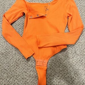 Orange ribbed a symmetrical body suit